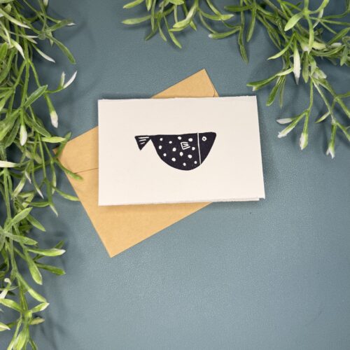 A mini card with a single fish design on a green background with a plant