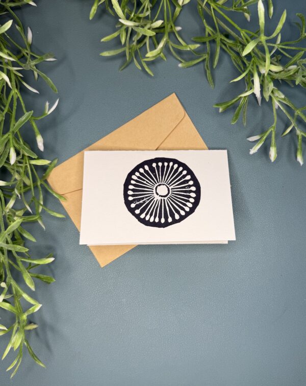 1 Wheel A mini card with a black single wheel design on a green background with a plant