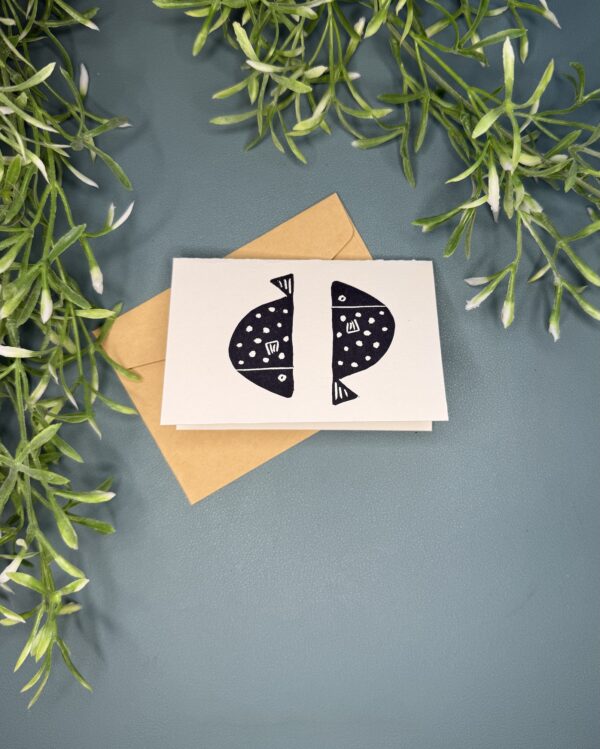 2 Fish A mini card with a black double fish design on a green background with a plant