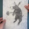 Aardvark Lokta print A black ink print of an Aardvark on natural Lokta paper held over a green background.