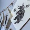 An Aardvark print hangs to dry after printing.