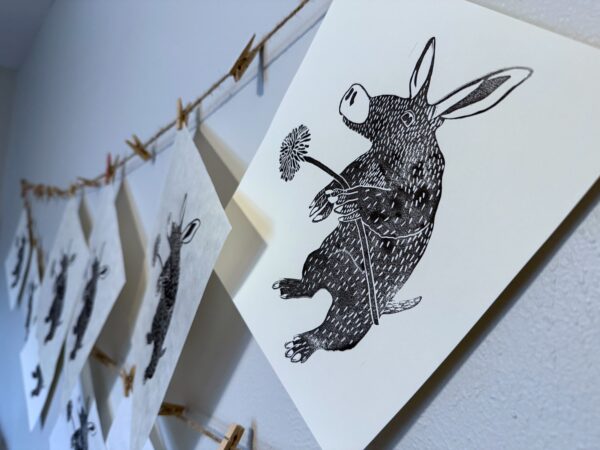 An Aardvark print hangs to dry after printing.