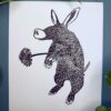 A black ink Aardvark on white paper on a green background with a plant