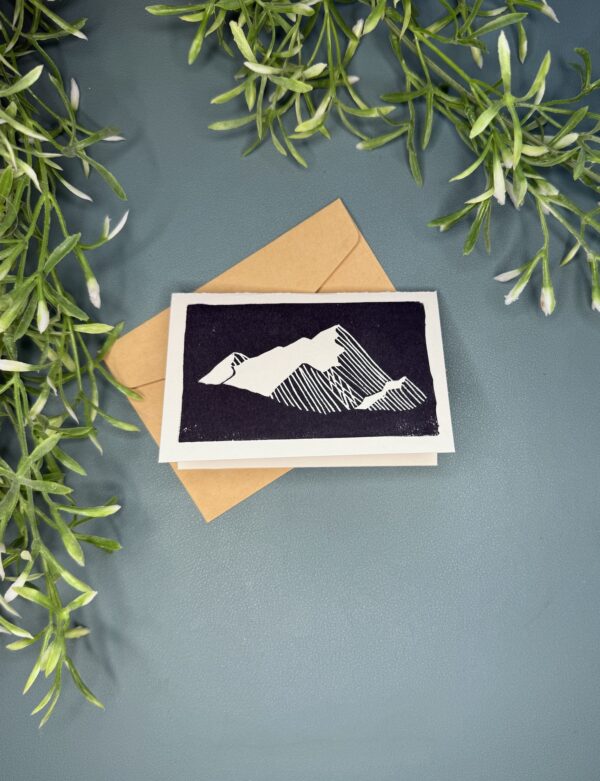 Mountain A mini card with a black and white mountain design on a green background with a plant